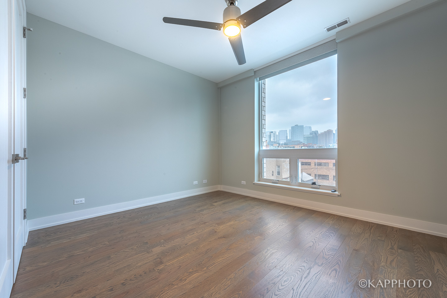 236 South Racine Avenue, Unit 401 Chicago, IL 60607 - Photo 23 of 24 an empty room with wooden floor and windows