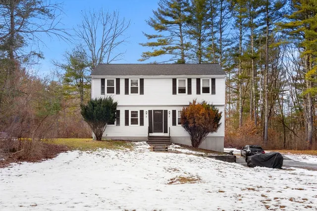 a view of a house with a snow in the background
