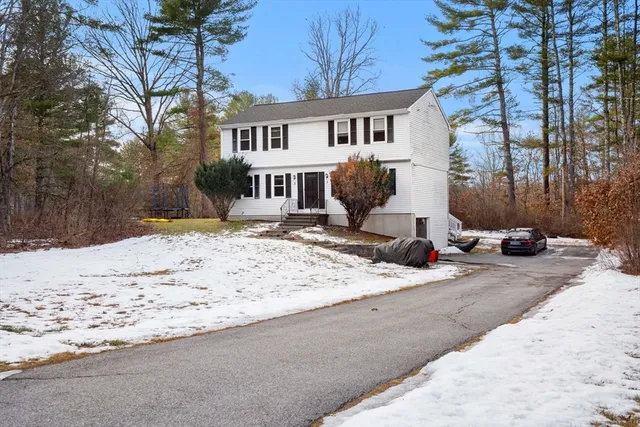 a view of a house with snow on the road