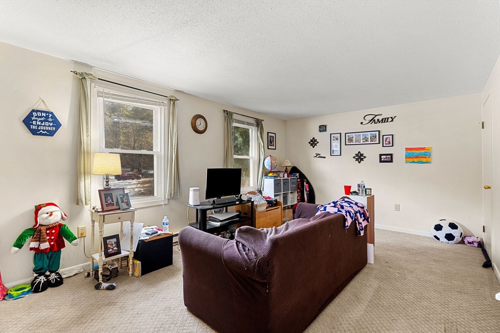 3-5 Roxanne Road Groton, MA 01450 - Photo 18 of 28 a living room with furniture and a flat screen tv