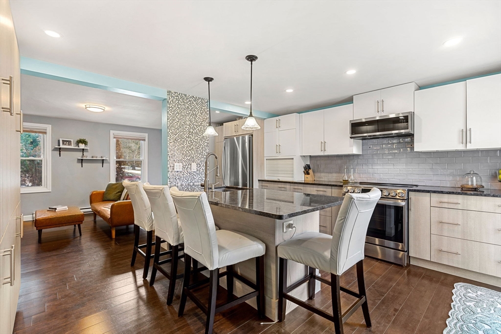 3-5 Roxanne Road Groton, MA 01450 - Photo 2 of 28 a view of kitchen with dining table chairs and wooden floor