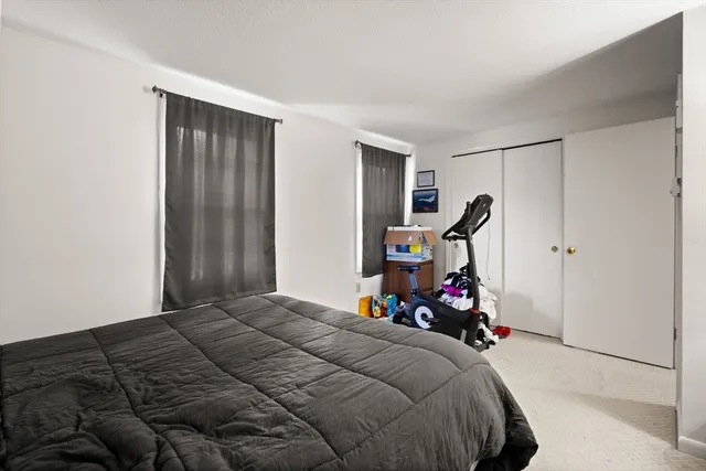 a bedroom with a bed and a mirror