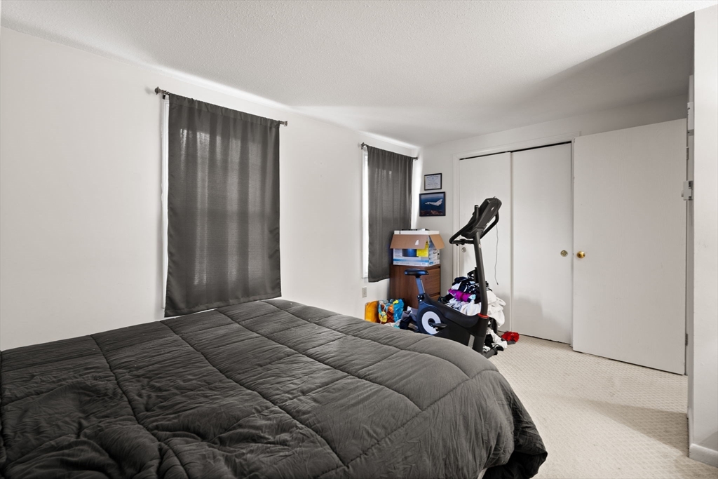 3-5 Roxanne Road Groton, MA 01450 - Photo 21 of 28 a bedroom with a bed and a mirror