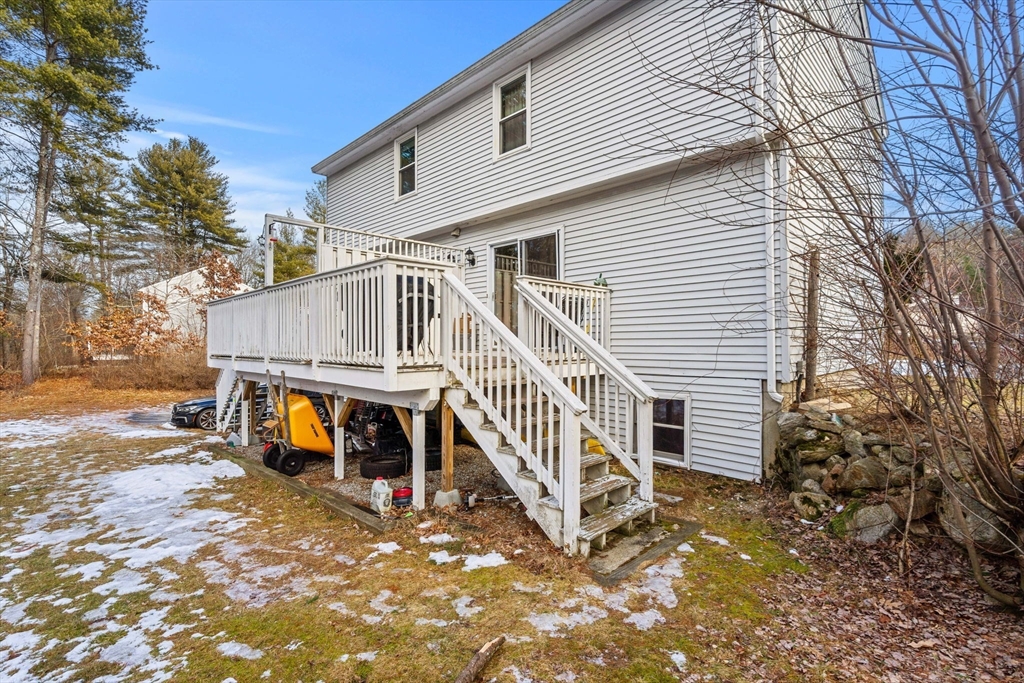3-5 Roxanne Road Groton, MA 01450 - Photo 26 of 28 a view of a house with wooden floor next to a yard