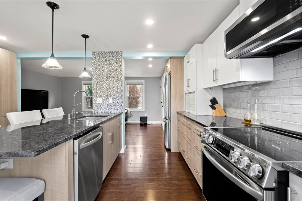 3-5 Roxanne Road Groton, MA 01450 - Photo 3 of 28 a kitchen with stainless steel appliances granite countertop a sink a stove and a wooden floors