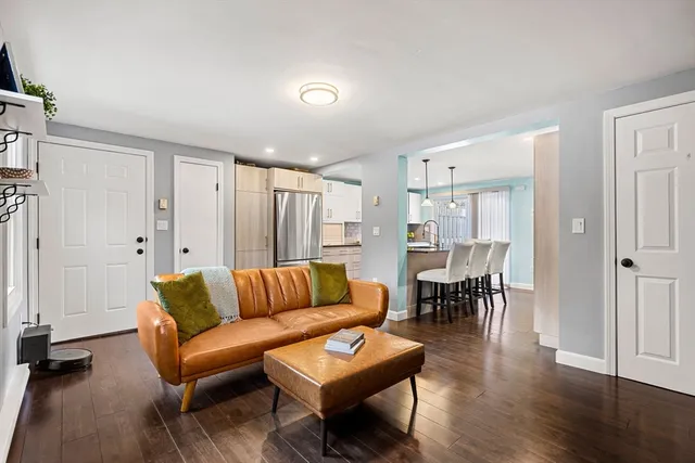 a living room with furniture wooden floor and a table