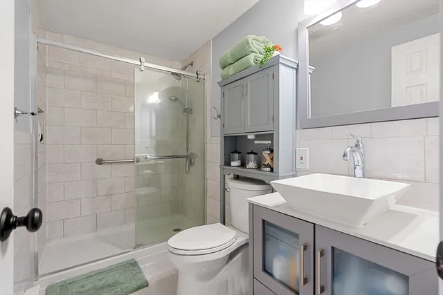 a bathroom with a sink toilet and shower