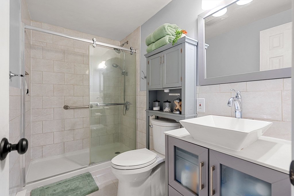 3-5 Roxanne Road Groton, MA 01450 - Photo 10 of 28 a bathroom with a sink toilet and shower