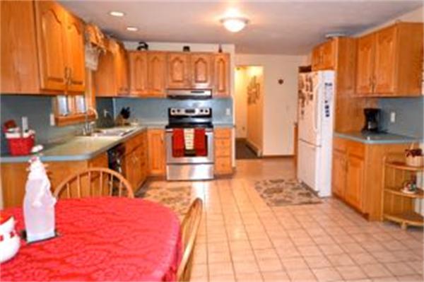 324 High Street Rochester, MA 02770 - Photo 17 of 23 a kitchen with stainless steel appliances kitchen island granite countertop a refrigerator a stove top oven and a sink