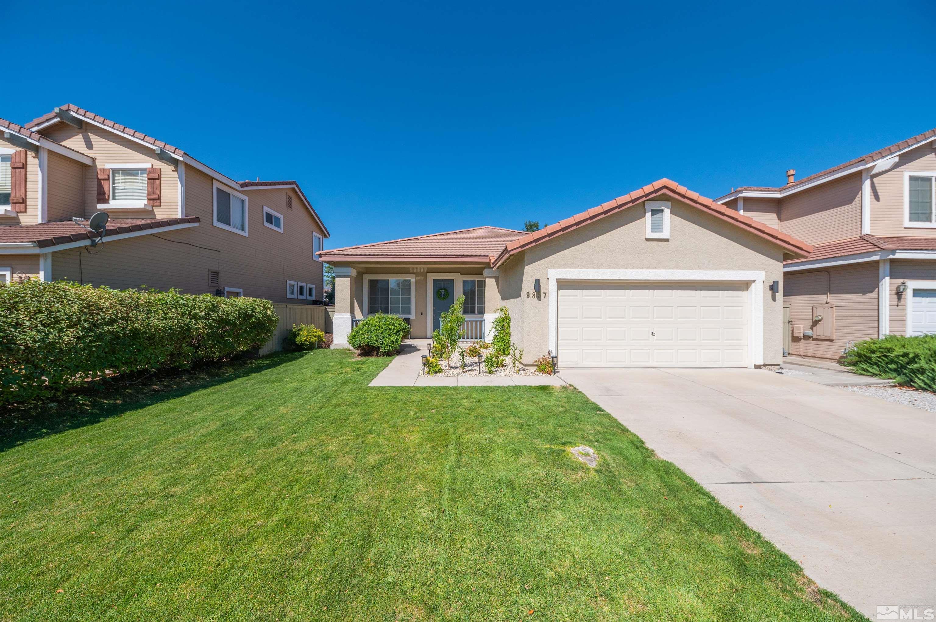 9857 Northrup Drive Reno, NV 89521 - Photo 1 of 27 a front view of a house with a yard and porch