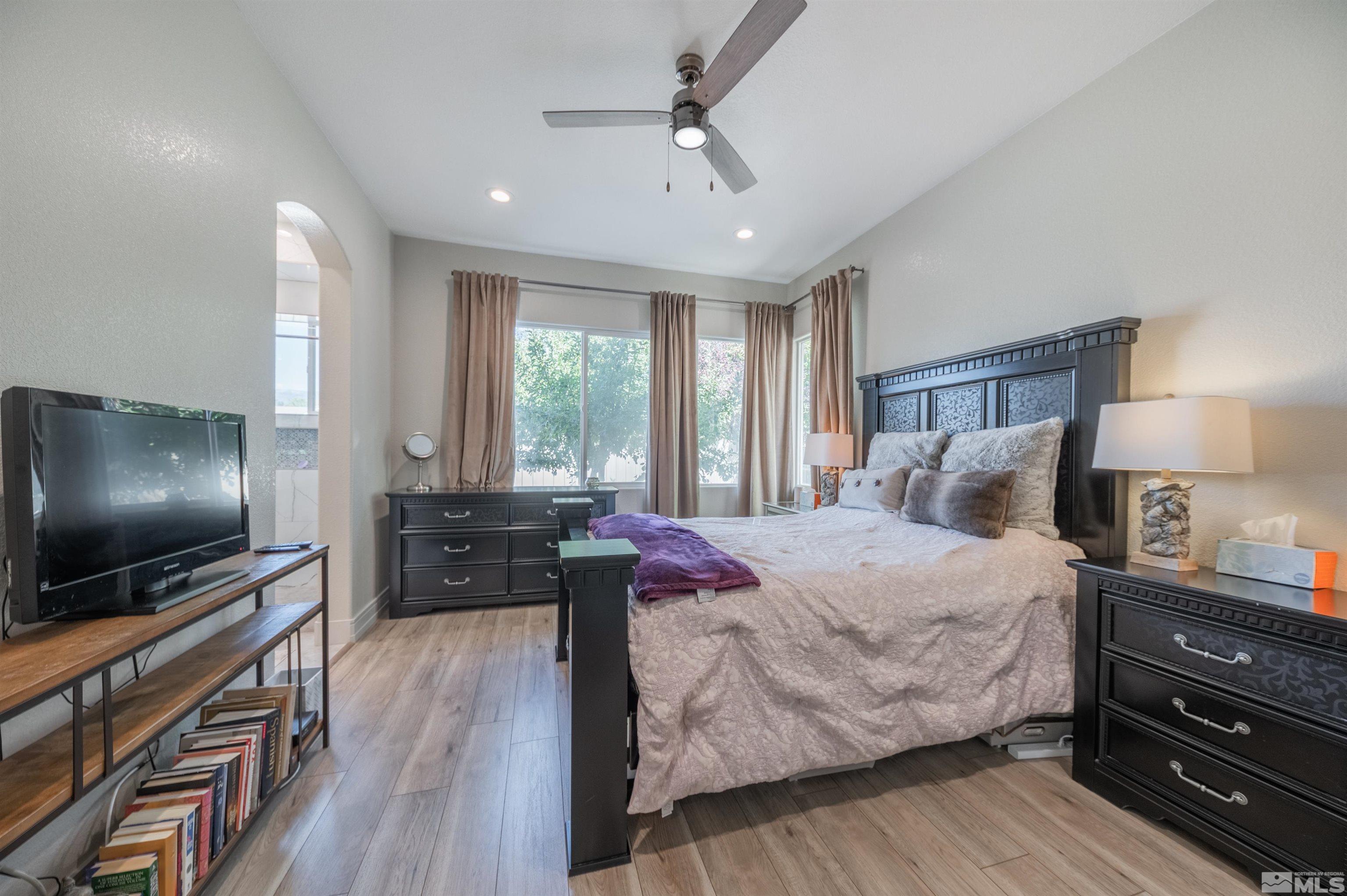 9857 Northrup Drive Reno, NV 89521 - Photo 16 of 27 a bedroom with a bed and a flat screen tv