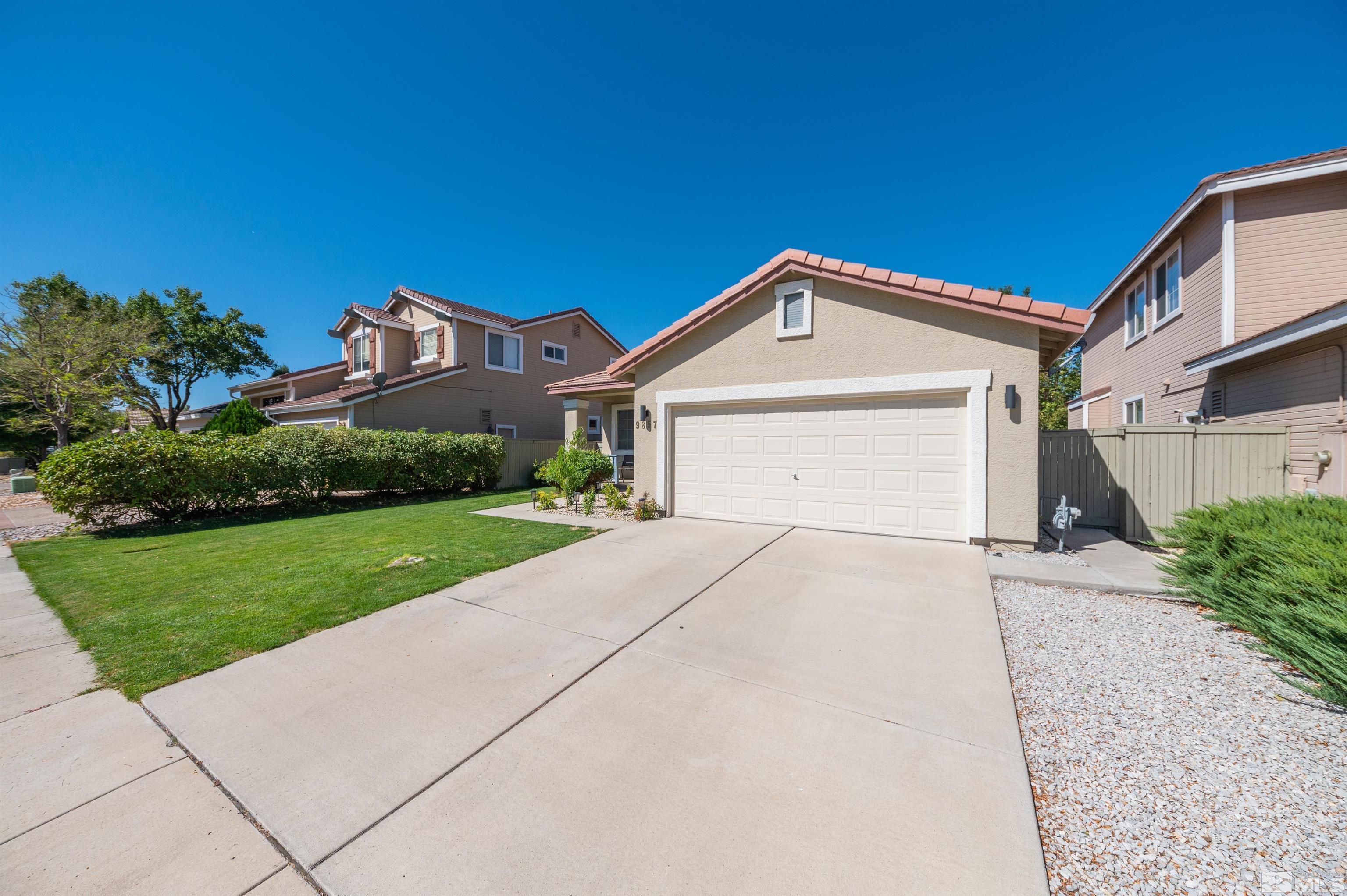 9857 Northrup Drive Reno, NV 89521 - Photo 2 of 27 a front view of a house with a yard and garage