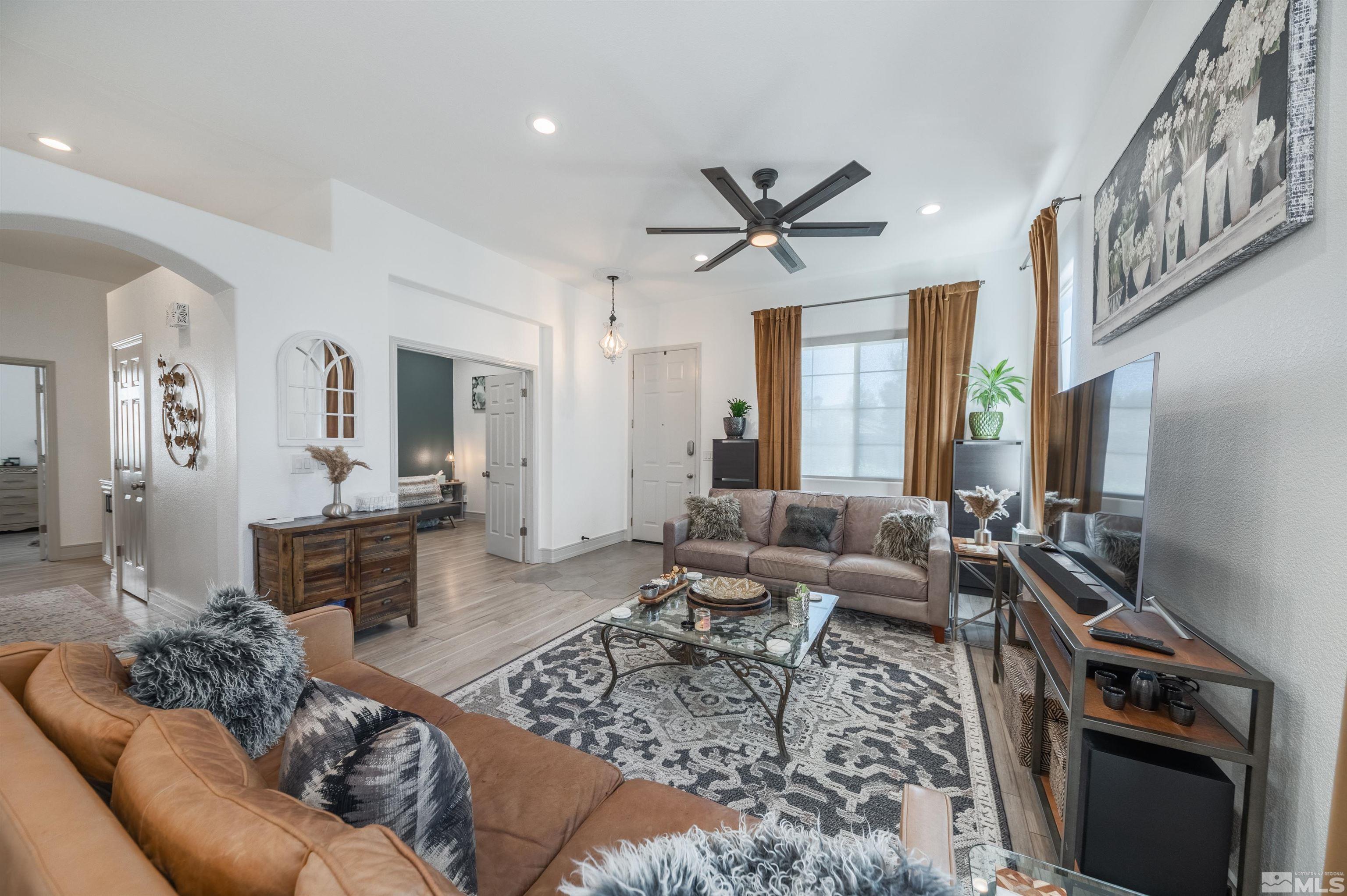 9857 Northrup Drive Reno, NV 89521 - Photo 6 of 27 a living room with furniture ceiling fan and a rug