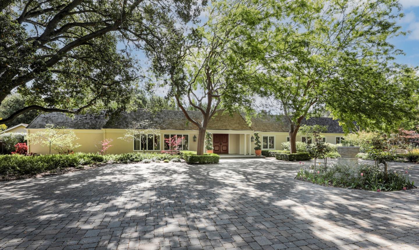 a front view of a house with a garden