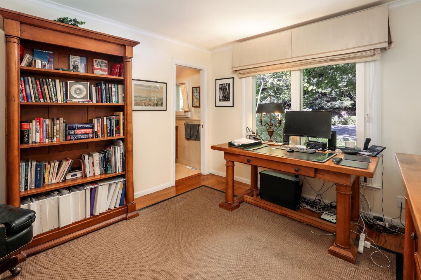 50 Barry Lane Atherton, CA 94027 - Photo 13 of 38 a view of a workspace with furniture and a bookshelf