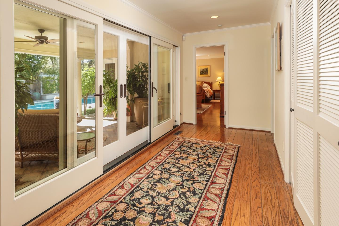 50 Barry Lane Atherton, CA 94027 - Photo 20 of 38 a view of a hallway with wooden floor and a living room