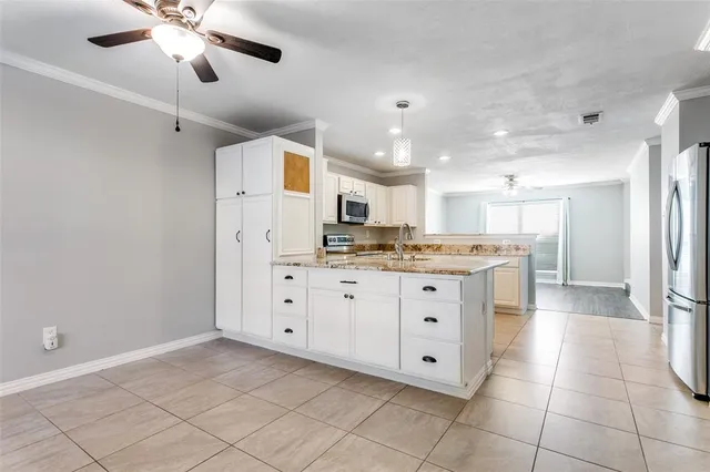a kitchen with cabinets and window