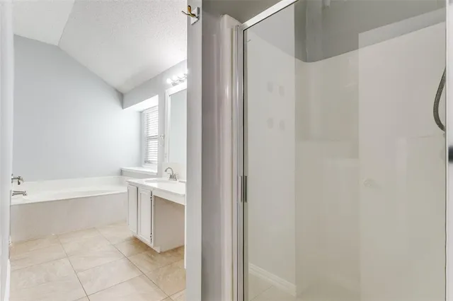 a bathroom with a bathtub and a shower