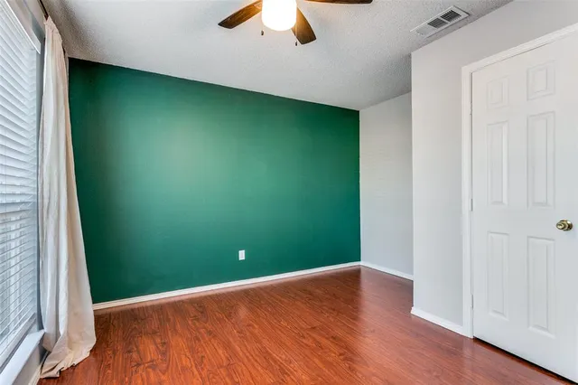 an empty room with closet and windows
