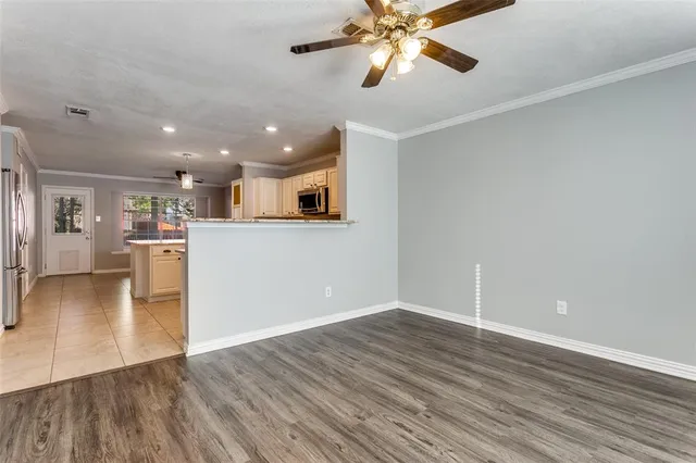 a view of a kitchen with a sink and a refrigerator
