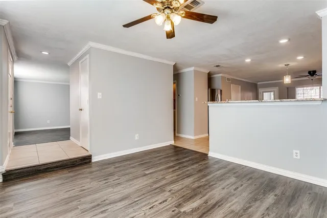 a view of an empty room and wooden floor