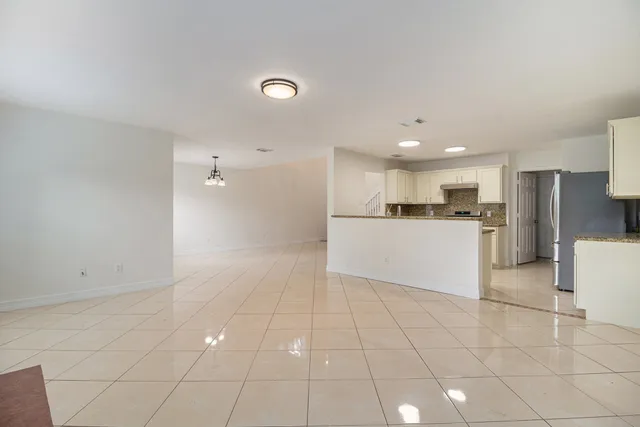 a view of a kitchen with a sink and a refrigerator