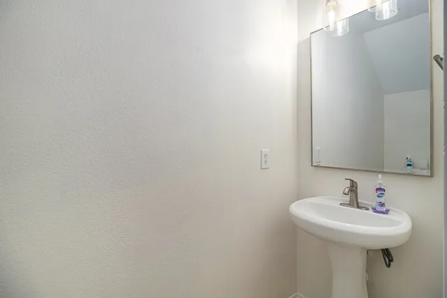 a bathroom with a sink and mirror