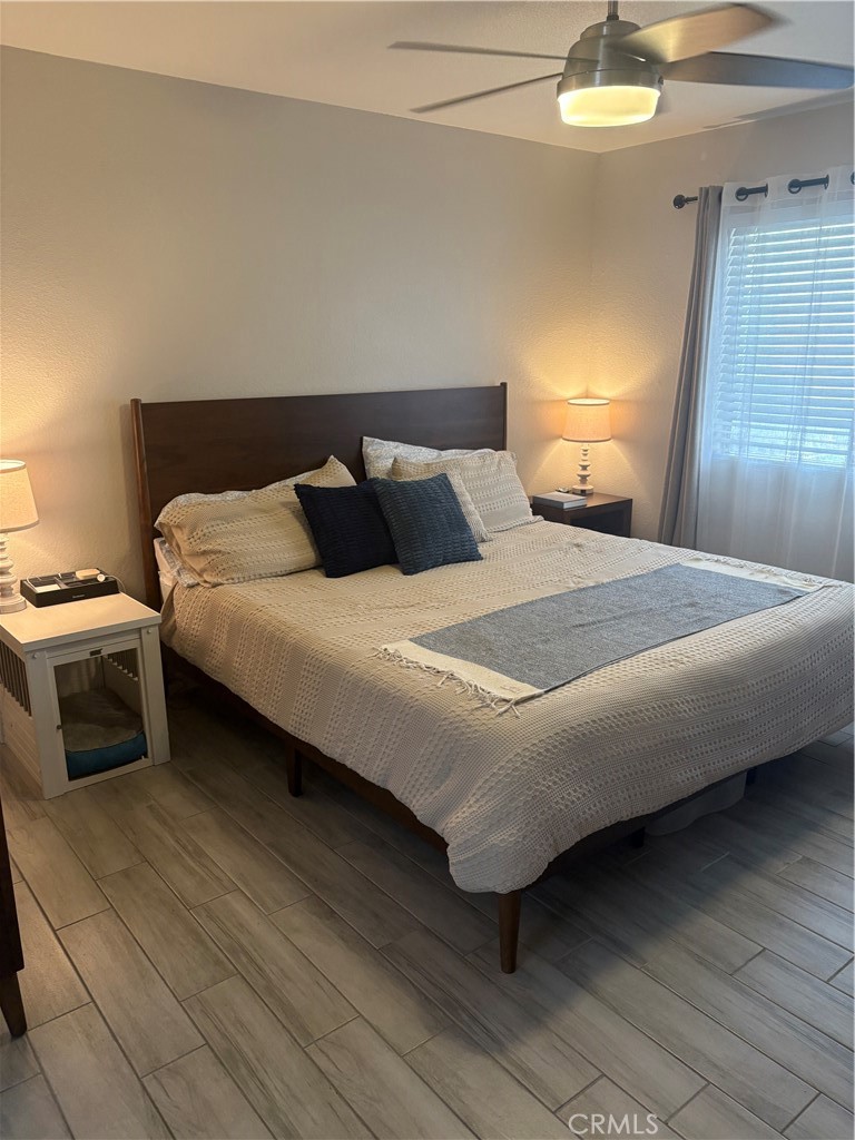 2255 Cahuilla Street, Unit 49 Colton, CA 92324 - Photo 14 of 19 a bedroom with a bed and a lamp