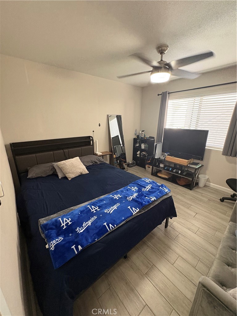 2255 Cahuilla Street, Unit 49 Colton, CA 92324 - Photo 17 of 19 a bed sitting in a bedroom and tv on table