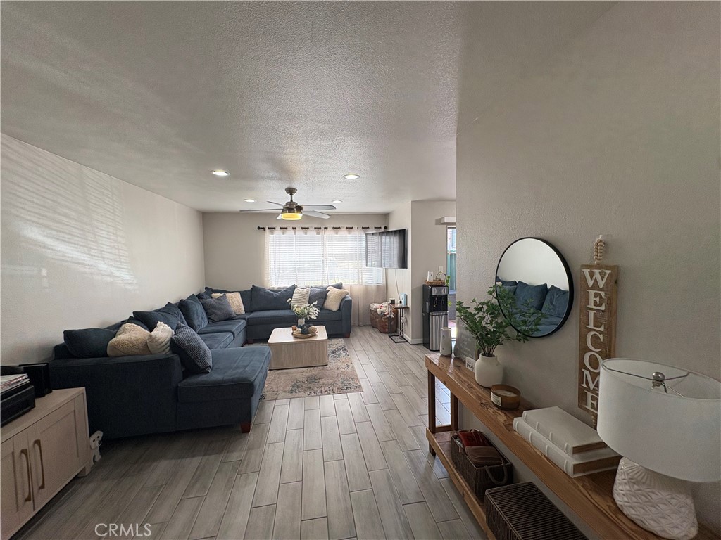2255 Cahuilla Street, Unit 49 Colton, CA 92324 - Photo 2 of 19 a living room with furniture and a large mirror