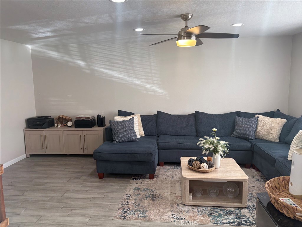 2255 Cahuilla Street, Unit 49 Colton, CA 92324 - Photo 3 of 19 a living room with furniture and a chandelier