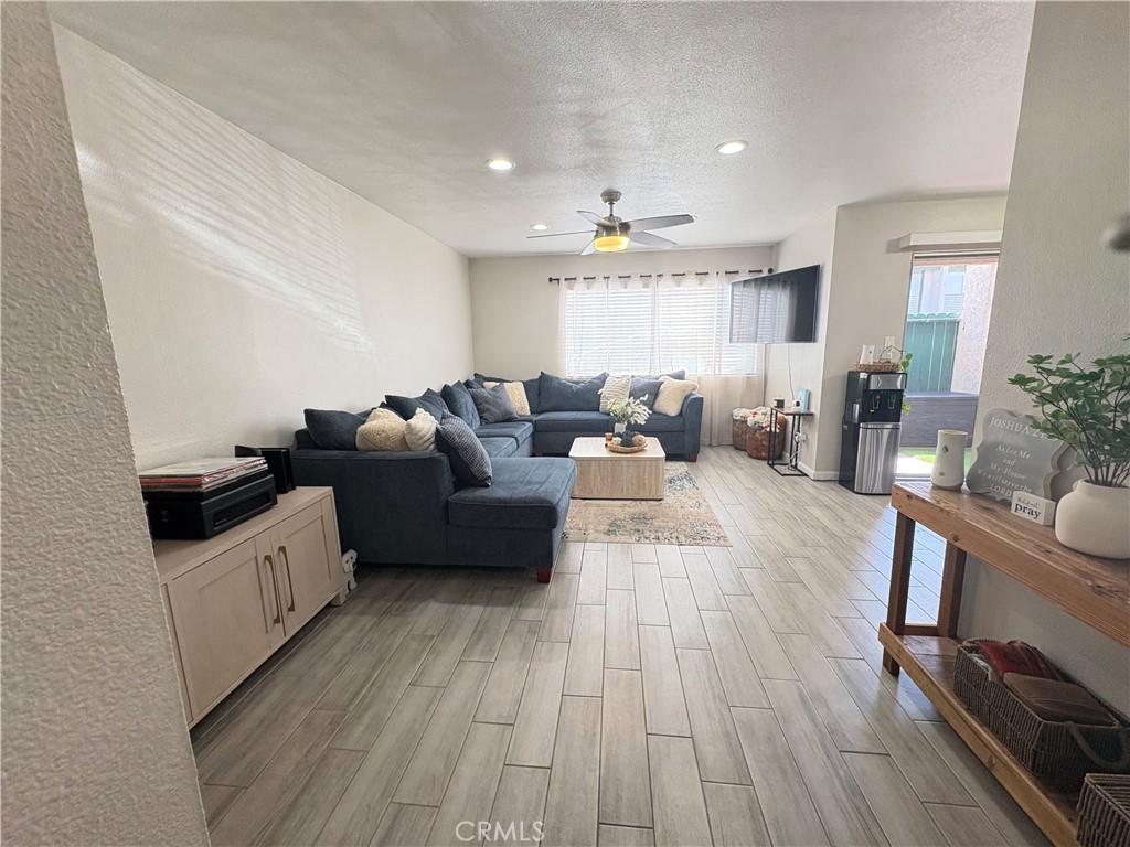2255 Cahuilla Street, Unit 49 Colton, CA 92324 - Photo 4 of 19 a living room with furniture and a wooden floor