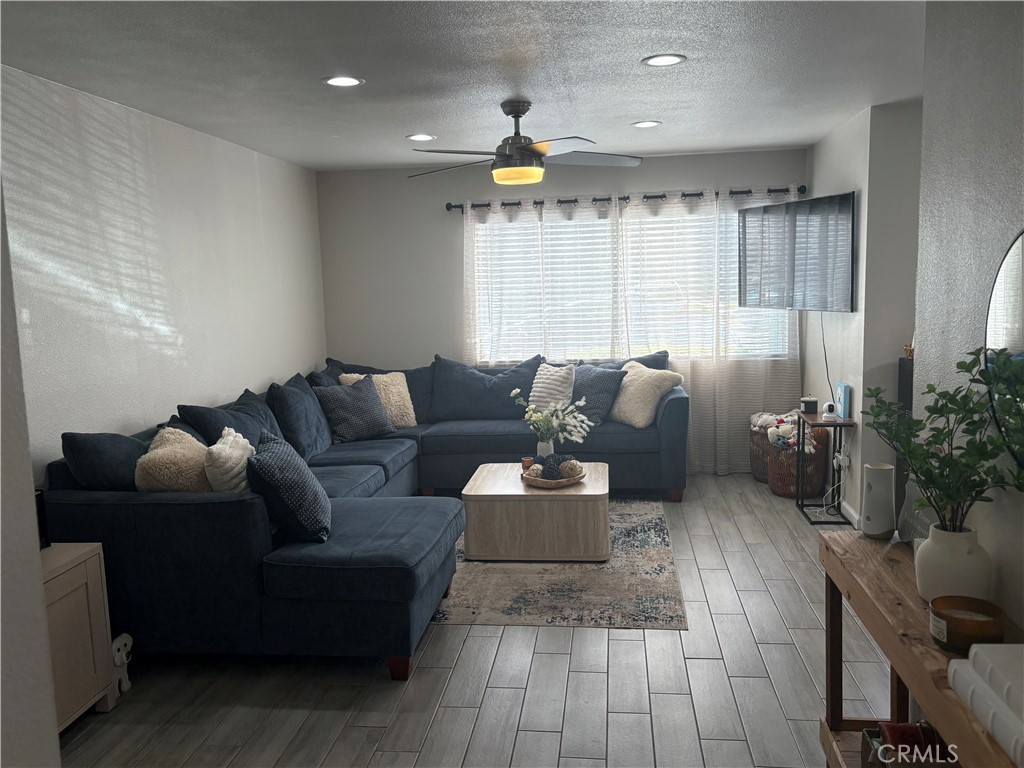 2255 Cahuilla Street, Unit 49 Colton, CA 92324 - Photo 5 of 19 a living room with furniture and a large window