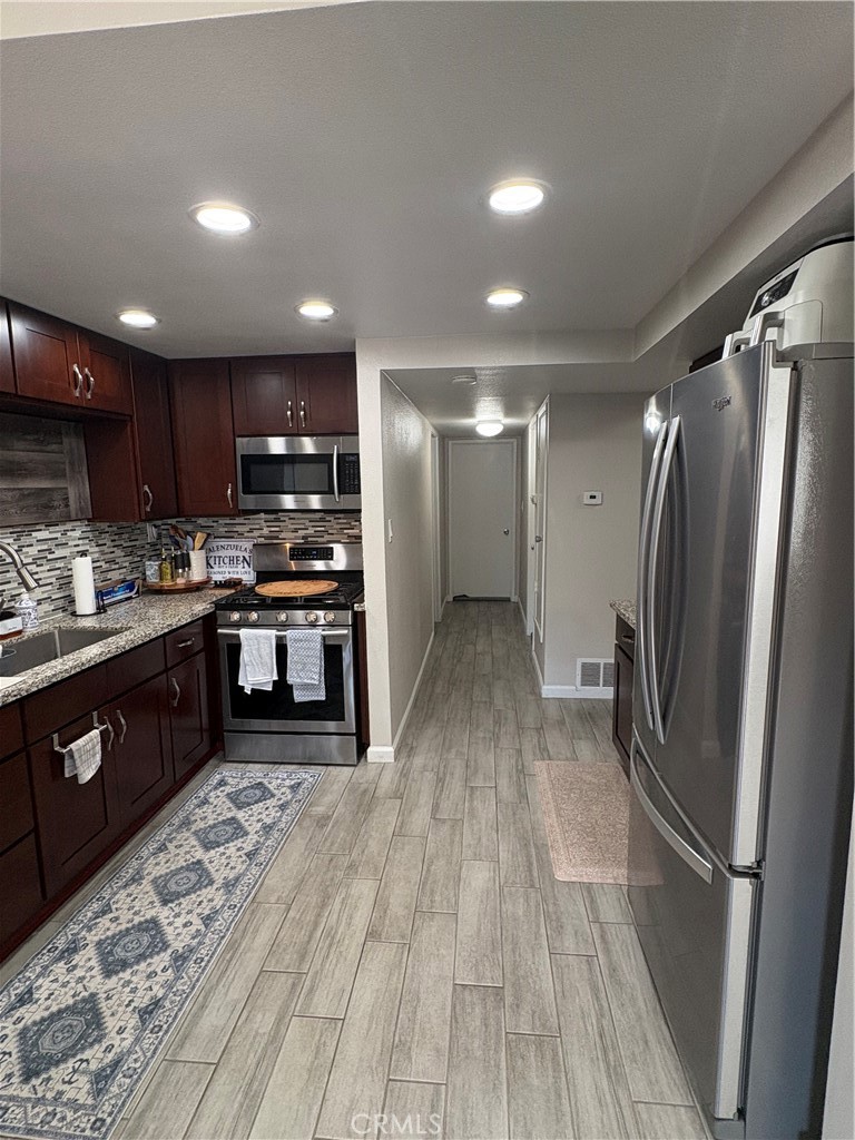 2255 Cahuilla Street, Unit 49 Colton, CA 92324 - Photo 7 of 19 a kitchen with stainless steel appliances granite countertop a refrigerator and a sink