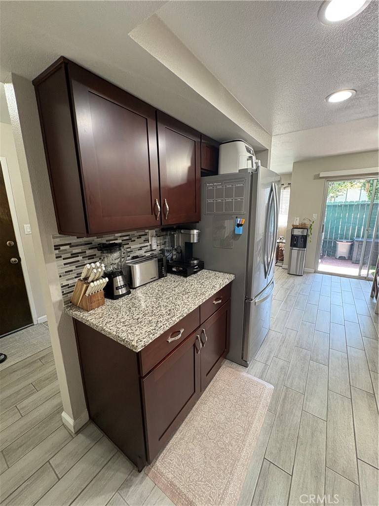 2255 Cahuilla Street, Unit 49 Colton, CA 92324 - Photo 8 of 19 a kitchen with stainless steel appliances granite countertop a sink stove and wooden floor