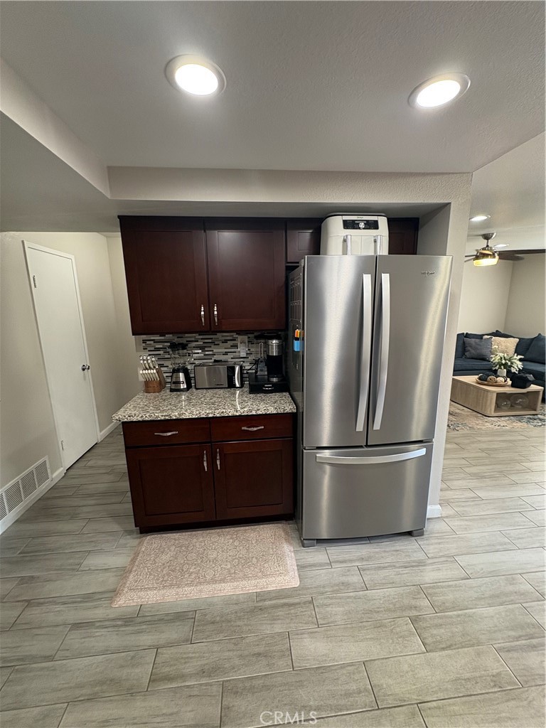 2255 Cahuilla Street, Unit 49 Colton, CA 92324 - Photo 10 of 19 a large kitchen with stainless steel appliances granite countertop a refrigerator a stove a sink and a microwave