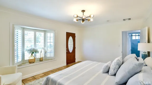 a bedroom with a large bed and a window