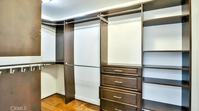 a view of walk in closet with empty racks