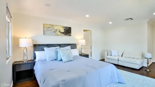 a bedroom with a bed and a couch