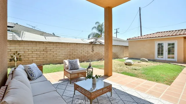 a view of a patio with a table and chairs