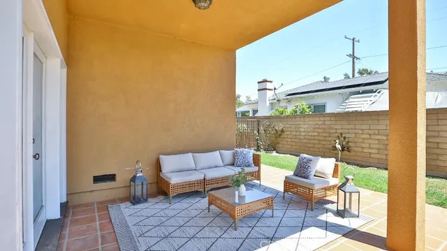a view of a patio with couple of chairs and a couch