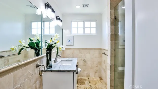 a view of a bathroom with a shower and a sink