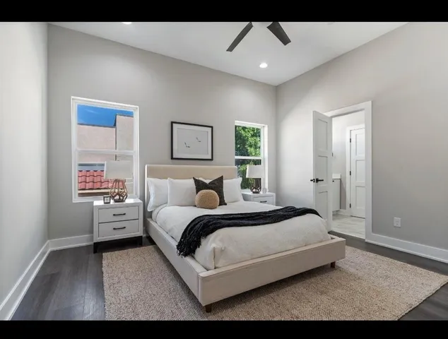 a bedroom with a bed and a painting on the wall