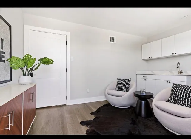 a view of a patio with table and chairs with wooden floor