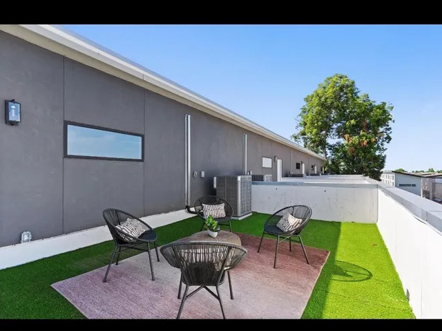 a view of a patio with table and chairs with wooden floor