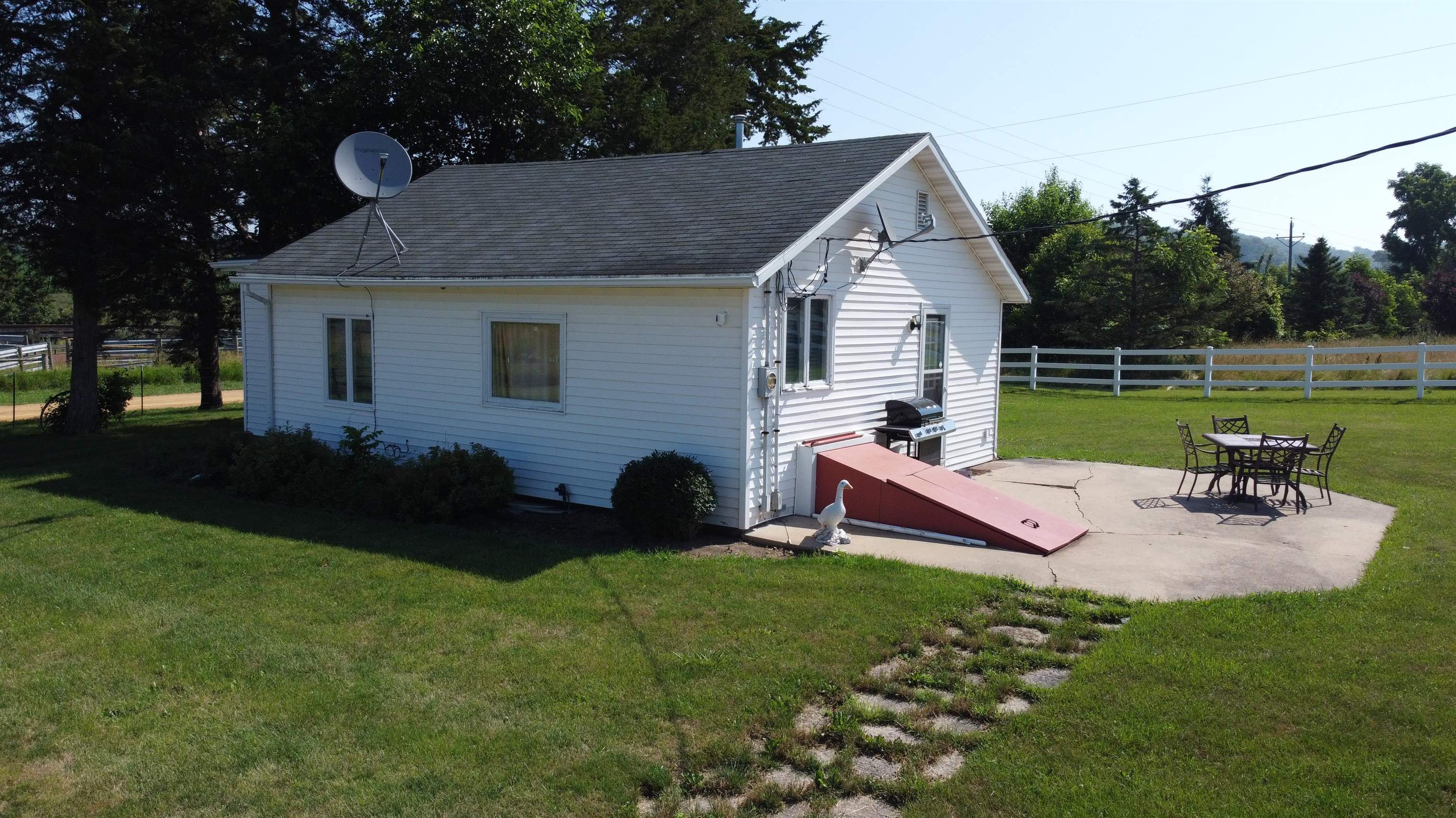 1735 West Steele Road Hanover, IL 61041 - Photo 40 of 70 a view of a house with backyard and a garden