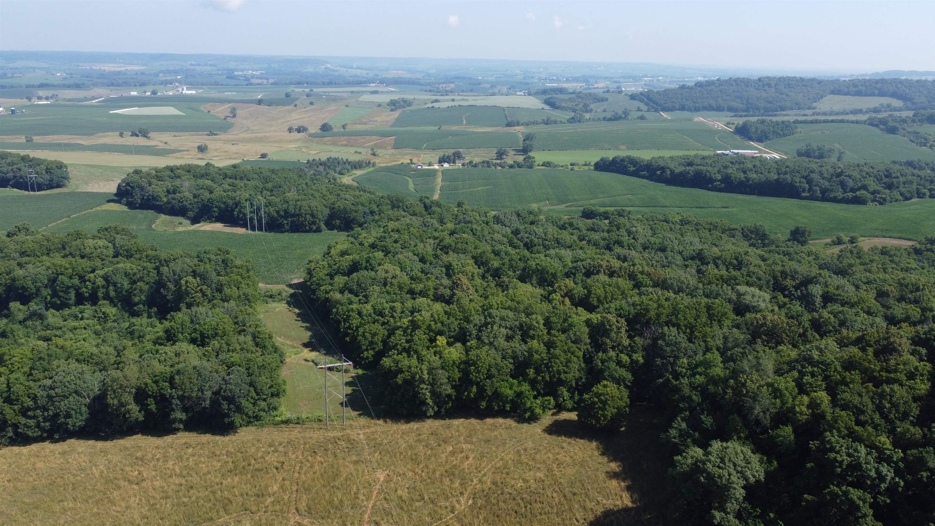 1735 West Steele Road Hanover, IL 61041 - Photo 52 of 70 an aerial view of green landscape with trees houses and mountain view