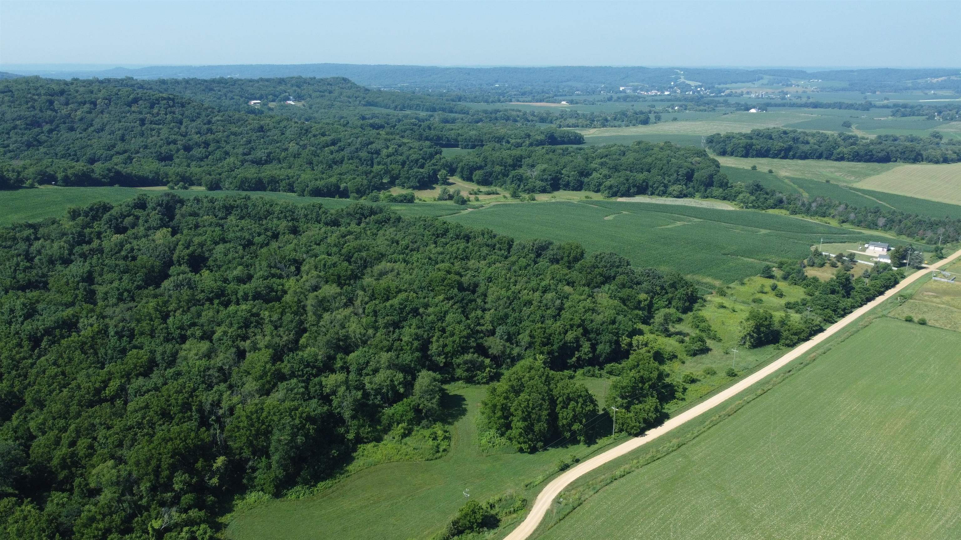 1735 West Steele Road Hanover, IL 61041 - Photo 61 of 70 a view of a lush green forest with a lake