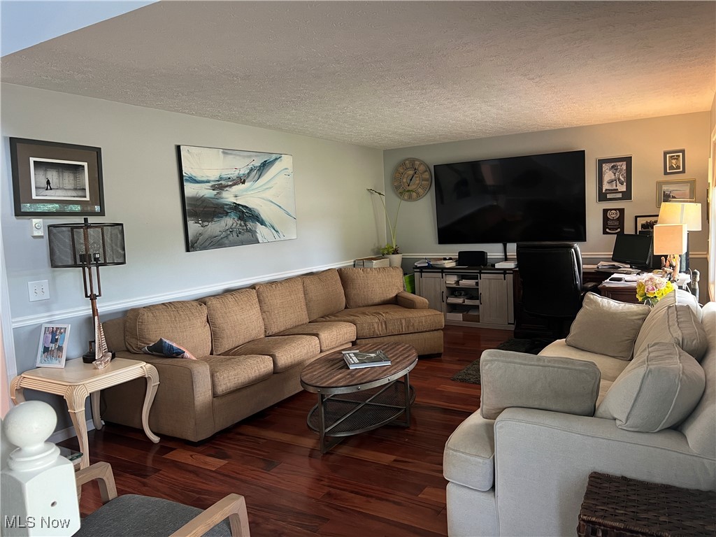 5912 Coen Road Vermilion, OH 44089 - Photo 4 of 28 Living room with a textured ceiling, wood finished floors, and a desk