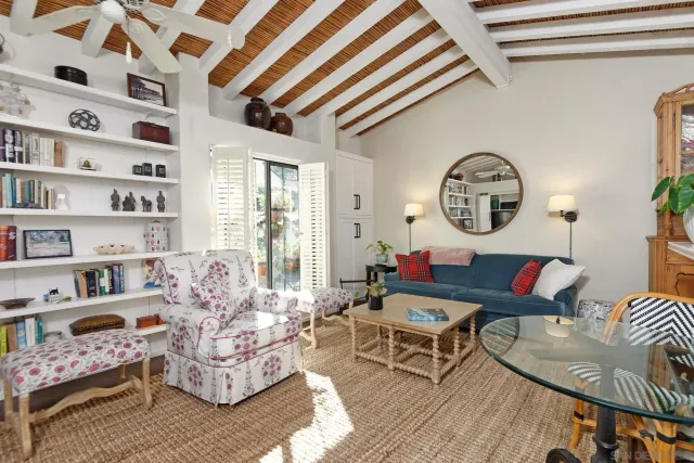 a living room with furniture a wooden floor and a chandelier